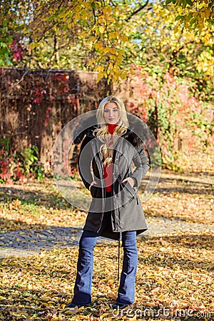 Autumn season fashion concept. Puffer jacket with hood. Woman wear black parka fur hood. Classic parka coat has become Stock Photo