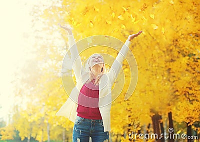 Autumn season is open! Leaf fall, happy expression young woman having fun in warm sunny Stock Photo