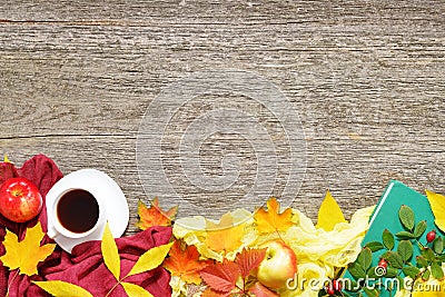 Autumn set of red, green and yellow leaves, apples with cup of coffee or tea with books on vintage background. Stock Photo