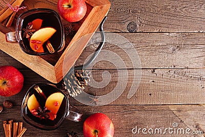 Autumn spiced tea with apples and pomegranates, top view side border with copy space on a wood background Stock Photo
