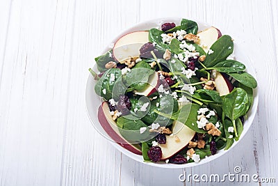 Autumn spinach salad with apple cheese , walnut and dried cranberry . Healthy vegetarian food Stock Photo