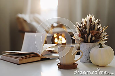 Autumn still life. Coffee cup, flowers, book and pumpkin. Hygge lifestyle, cozy autumn mood. Flat lay, Happy thanksgiving Stock Photo