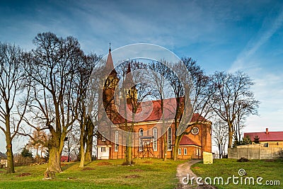 Autumn sun setting illuminates the walls of the church. Stock Photo