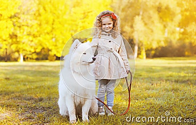 Autumn sunny photo child and dog walking in the park Stock Photo