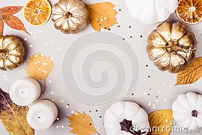 Autumn or thanksgiving day concept. Golden pumpkin, dry leaves and candle frame on gray background Stock Photo