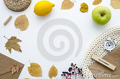 Autumn time. Frame with dry leaves, scarf, alarm clock, envelopes,yellow lemon and green apple. Autumn flat lay mockup Stock Photo