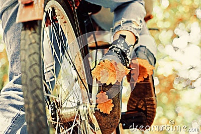 Autumn tree leaves and vinrage bike. Fall concept. Riding the bicycle in the park. Active people. Outdoors. Enjoying Stock Photo