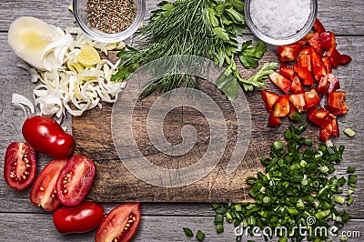 Autumn vegetables and herbs on a cutting board with spices and salt on wooden background close up top view space for text Stock Photo