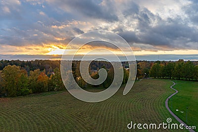 autumn view from the observation tower of birch trees, mown grass and sunset, path on the right Stock Photo