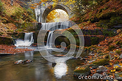 Autumn waterfalls near Sitovo, Plovdiv, Bulgaria. Beautiful cascades of water with fallen yellow leaves. Stock Photo