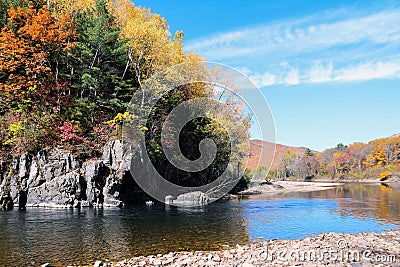 Autumn wild forest, rocks and river. Vivid landscape, colorful scene with water Stock Photo
