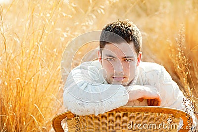 Autumn winter man portrait in golden grass field Stock Photo