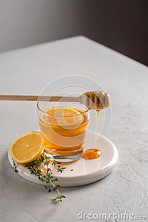 Autumn and winter traditional drinks. Warming hot tea with lemon, honey and thyme. Healthy drink Stock Photo