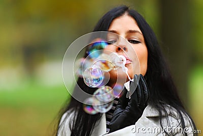 Autumn woman blow bubbles Stock Photo