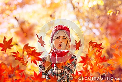 Autumn woman blowing fall leaves Stock Photo