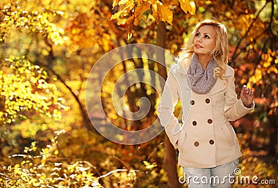 Autumn Woman. Fall. Blonde Beautiful Girl with Yellow Leaves Stock Photo