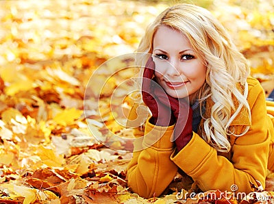 Autumn Woman with Maple leaves. Blonde Beautiful Girl in Fall Stock Photo