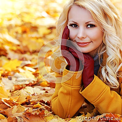 Autumn Woman with Maple leaves. Blonde Beautiful Girl in Fall Stock Photo