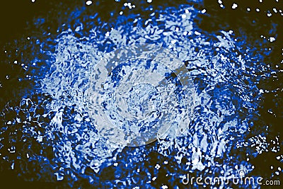 Autumnal blue blurry abstract water background. Formed from sunny reflections of forest trees and movement in a river Stock Photo