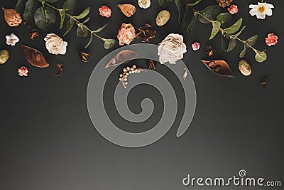 Autumnal-winter concept with dried flowers, branches of eucalyptus, leaves and berries on dark background. Frame of plants. Flat Stock Photo