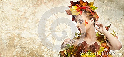 Autumnal woman. Beautiful creative makeup and hair style in fall concept studio shot. Beauty fashion model girl with fall makeup Stock Photo