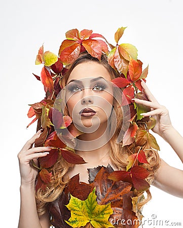 Autumnal woman. Beautiful creative makeup and hair style in fall concept studio shot. Beauty fashion model girl with fall makeup Stock Photo