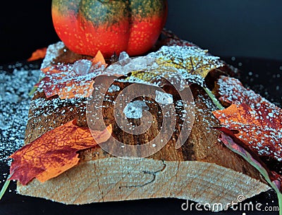 Autumnally decorated ice crystals with pumpkin,snow and autumn foliage Stock Photo