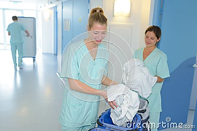 Auxiliary nurses collecting laundry Stock Photo