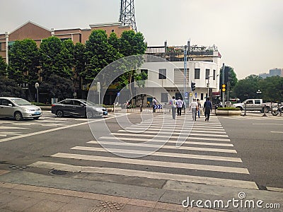 Auxiliary police leading pedestrians walking across the road. Editorial Stock Photo