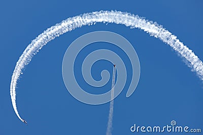 Melissa Andrzejewski flying an Edge 540 aerobatic aircraft around Wing suit flyer Rex Pemberton. Editorial Stock Photo