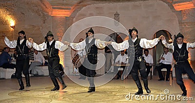 Avanos / Turkey - April 25, 2013: Traditional Turkish dancers dance for tourists in a local restaurant Editorial Stock Photo