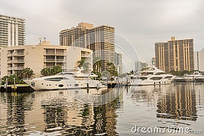 Urban Landscape in Aventura waterway with skies, water, boat, reflections and buildings Editorial Stock Photo