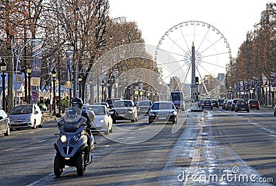 Avenue Champs-Elysees with ferris wheel at horizon in Paris, France Editorial Stock Photo