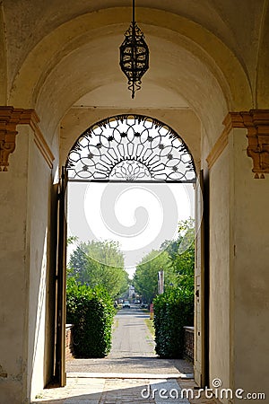 Avenue with door and wrought iron railing. Triumphal arch Editorial Stock Photo