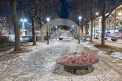 Avenue in Oslo on Karl Johans street during night in winter, with icy ground and light lamps turned on. Beautiful winter night in Stock Photo
