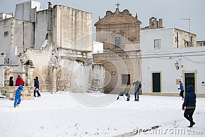 Avetrana, Italy - January 5, 2019. Group of young people playing outdoor snowballs in snowy square after snowfall in Puglia, Editorial Stock Photo