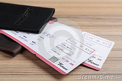 Avia tickets and passports on wooden table, closeup. Travel agency concept Stock Photo