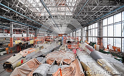 Aviation factory of military aircraft. Assembly of the Russian multirole fighter. Room with many pla Stock Photo