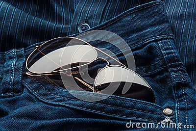 Aviator sunglasses in jeans pocket Stock Photo