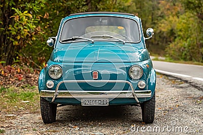 Avigliana, Italy. October 10th, 2020. Front view of classic old FIAT 500L in blue marine color parked along the road leading to Editorial Stock Photo