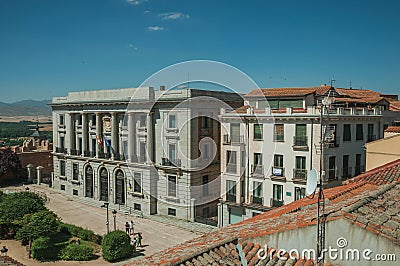 Sumptuous building with flags in front of square at Avila Editorial Stock Photo
