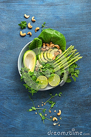 Avocado, asparagus, micro greens, lime, mint, lettuce and cashew nuts. Detox bowl buddha. Blue rustic background, top view. Clean, Stock Photo