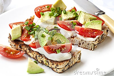 Avocado Cream Cheese and Tomatoes on Wholewheat Toast Stock Photo