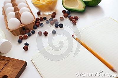 Avocado, dry berries, eggs and cheese, we are ready to write a new healthy recipe Stock Photo
