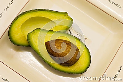 Avocado halves on plate Stock Photo