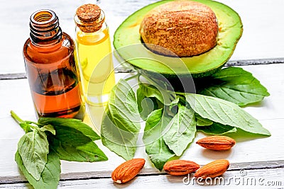 Avocado oil for handmade cosmetics on wooden background Stock Photo