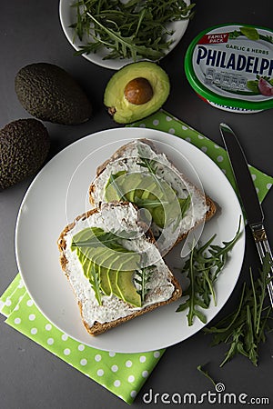 Avocado sandwich toast bread made with fresh sliced avocado, cream cheese. healthy food concept. Gray background. Food. Breakfast Editorial Stock Photo