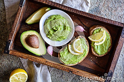 Avocado spread with garlic on wholewheat slice of bread Stock Photo