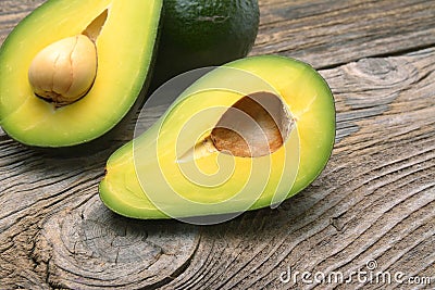 Avocados one cut in two with seed Stock Photo