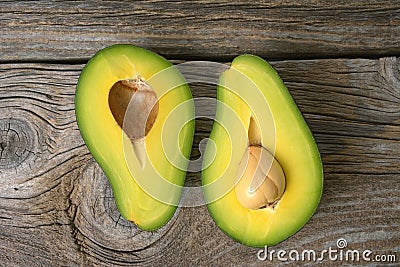 Avocados one cut in two with seed Stock Photo